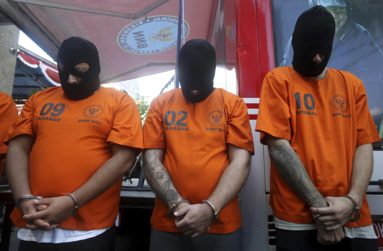 Foreign suspects detained on drugs charges are displayed during a news conference in Bali, Indonesia on Friday, Aug. 5, 2022. Authorities in Indonesia arrested three foreigners, for distributing cocaine on the Indonesian resort island of Bali at the end of July. From the three suspects that are identified as British, Brazilian and Mexican, the officers from the National Narcotics Agency seized 844.59 gram (1.86 pounds) of cocaine with other drugs, including MDMA and marijuana.