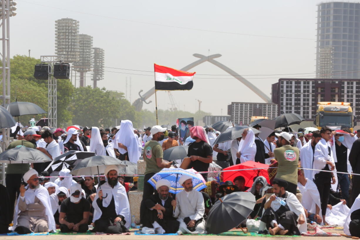 Followers of Shiite cleric Muqtada al-Sadr gather during an open-air Friday prayers at Grand Festivities Square within the Green Zone, in Baghdad, Iraq, Friday, Aug. 5, 2022.