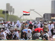 Followers of Shiite cleric Muqtada al-Sadr gather during an open-air Friday prayers at Grand Festivities Square within the Green Zone, in Baghdad, Iraq, Friday, Aug. 5, 2022.