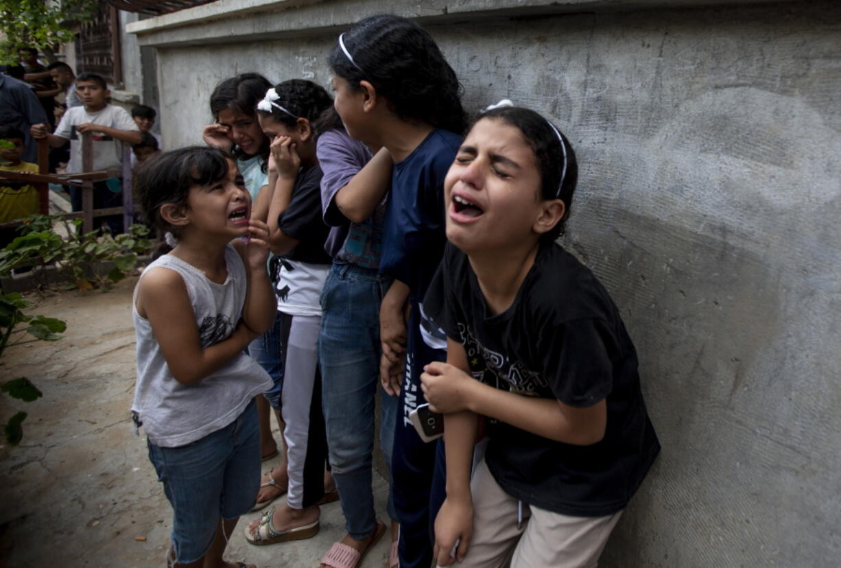 Mourners react during the funeral of Palestinian Tamim Hijazi, who was killed in an Israeli air strike, in Khan Yunis in the southern Gaza Strip, Saturday, Aug. 6, 2022. Israeli jets pounded militant targets in Gaza as rockets rained on southern Israel, hours after a wave of Israeli airstrikes on the coastal enclave killed at least 11 people, including a senior militant and a 5-year-old girl. The fighting began with Israel's dramatic targeted killing of a senior commander of the Palestinian Islamic Jihad continued into the morning Saturday, drawing the sides closer to an all-out war.