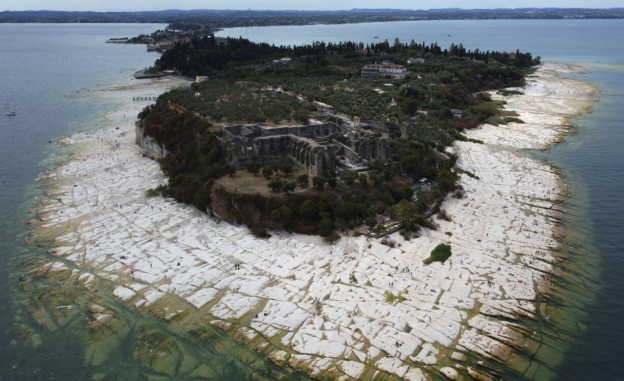 A view of the Sirmione Peninsula, on Lake Garda in Italy, on Friday shows that the water level has dropped critically during the severe drought, resulting in rocks that used to be underwater being exposed around the peninsula.