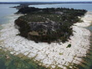 A view of the Sirmione Peninsula, on Lake Garda in Italy, on Friday shows that the water level has dropped critically during the severe drought, resulting in rocks that used to be underwater being exposed around the peninsula.