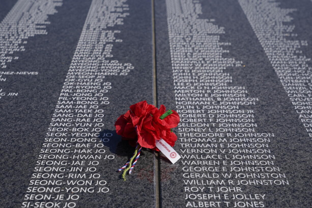 A bouquet rests on a section of the Korean War Veterans Memorial's newly unveiled Wall of Remembrance on July 27 in Washington, D.C.