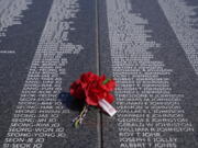 A bouquet rests on a section of the Korean War Veterans Memorial's newly unveiled Wall of Remembrance on July 27 in Washington, D.C.