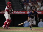 Seattle Mariners' Adam Frazier watches his two-run triple during the ninth inning of the team's baseball game against the Los Angeles Angels onTuesday, Aug. 16, 2022, in Anaheim, Calif.