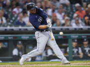 Seattle Mariners' Ty France hits a one-run single against the Detroit Tigers in the third inning of a baseball game in Detroit, Tuesday, Aug. 30, 2022.