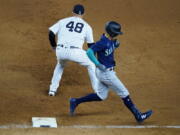 Seattle Mariners' Sam Haggerty, right, runs past New York Yankees' Anthony Rizzo (48) for a single during the ninth inning of a baseball game Tuesday, Aug. 2, 2022, in New York.