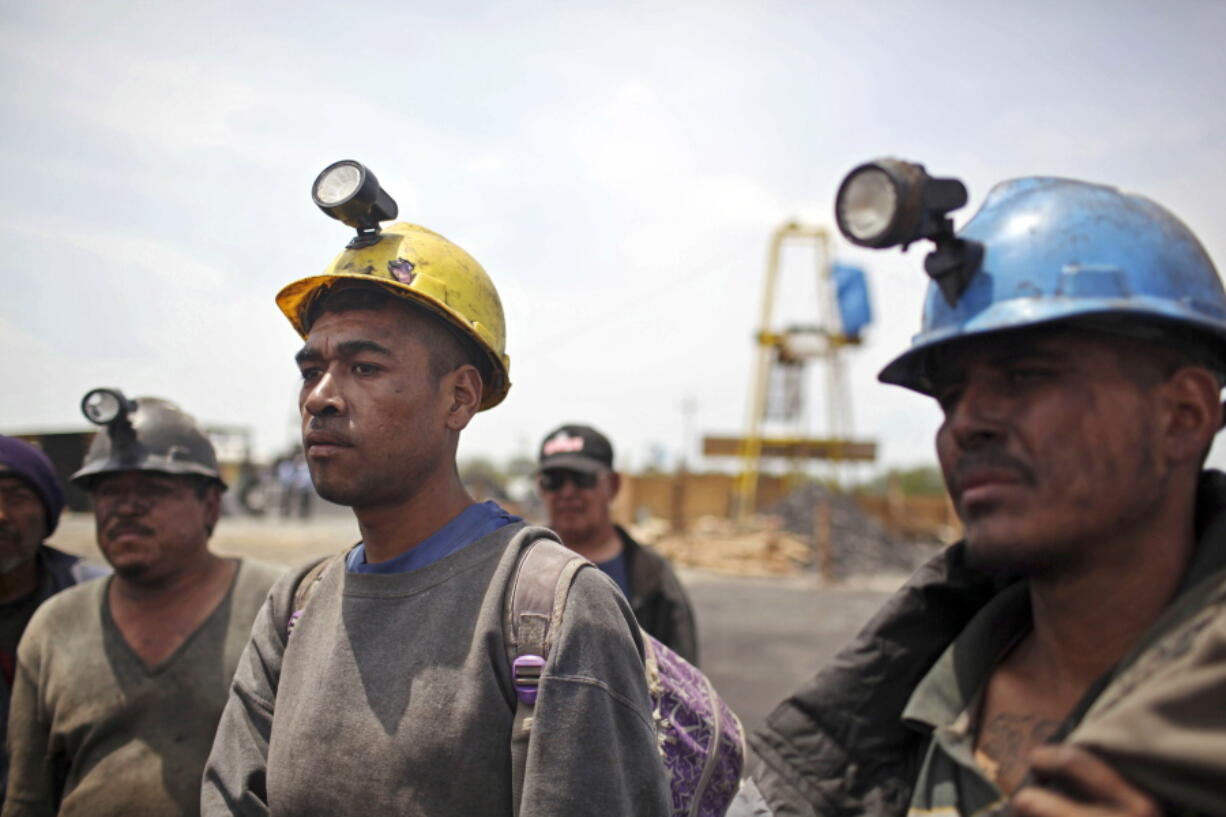 FILE - Miners helping in the rescue operation of fellow trapped miners are interviewed in San Juan de Sabinas, Coahuila state, Mexico, May 4, 2011. The administration of Mexican President Andres Manuel Lopez Obrador has resuscitated a form of coal mining so dangerous and primitive that both houses of Mexico's Congress tried to ban it in 2012.