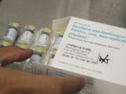 FILE - Jonathan Parducho, a pharmacist, removes a tray of vials of of the Jynneos vaccine for monkeypox from a box containing 20 doses, in the vaccine hub at Zuckerberg San Francisco General Hospital, July 29, 2022, in San Francisco. The U.S. will declare a public health emergency to bolster the federal response to the outbreak of monkeypox that already has infected more than 6,600 Americans. That's according to two people familiar with the matter said.