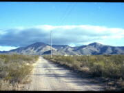 A dirt road leads to what was once the home of Paul Adams and his family on the outskirts of Bisbee, Ariz., Oct. 26, 2021. Adams, a Mormon and U.S. Border Patrol agent living with his wife and six children, admitted he had posted videos on the dark web of him molesting two of his children, a 9-year-old girl and a younger daughter he began raping when she was only 6 months old. Adams committed suicide after his arrest. The revelation that Mormon officials directed an effort to conceal years of abuse in the Adams household sparked a criminal investigation of the church by Cochise County attorney and a civil lawsuit by three of the Adams' children.