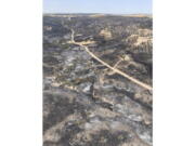 In this photo provided by the Nebraska Forest Service, the Carter Canyon wildfire burns in western Nebraska on Monday, Aug. 1, 2022 in Neb. Fire crews battling a western Nebraska wildfire that has destroyed some homes looked Tuesday, Aug, 2, to the skies with hope and trepidation as weather forecasters warned of thunderstorms.