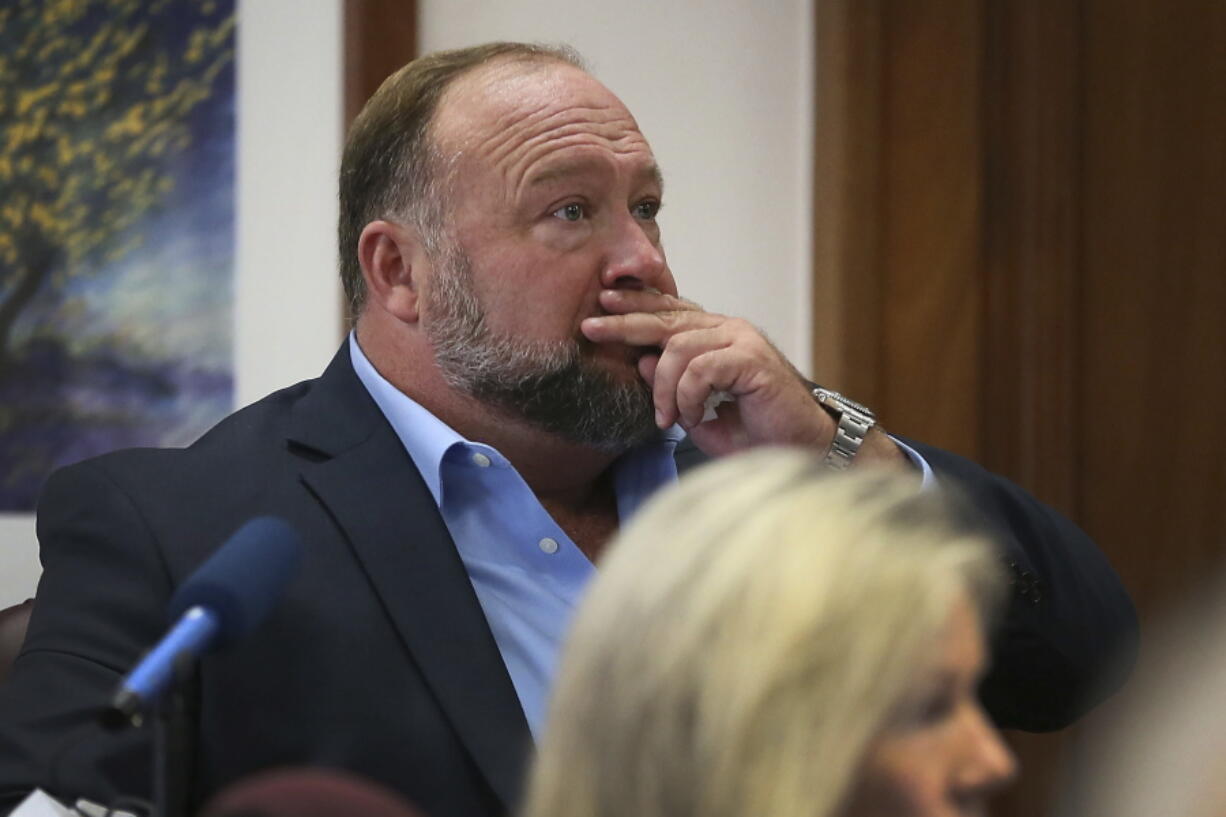 Alex Jones attempts to answer questions about his text messages asked by Mark Bankston, lawyer for Neil Heslin and Scarlett Lewis, during trial at the Travis County Courthouse in Austin, Wednesday Aug. 3, 2022.