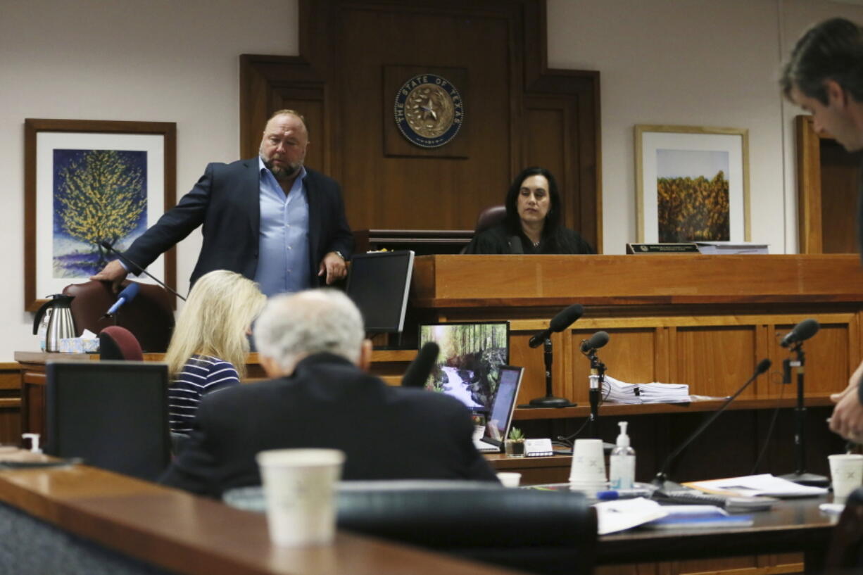 Alex Jones takes a seat to testify in court at t the Travis County Courthouse, Wednesday Aug. 3, 2022, in Austin, Texas.