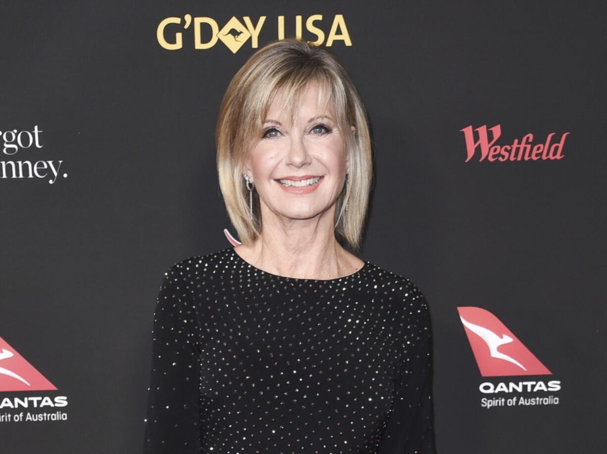 FILE - Actress and singer Olivia Newton-John attends the 2018 G'Day USA Los Angeles Gala in Los Angeles on Jan. 27, 2018. Newton-John, a longtime resident of Australia whose sales topped 100 million albums, died Monday at her southern California ranch, John Easterling, her husband, wrote on Instagram and Facebook. She was 73.