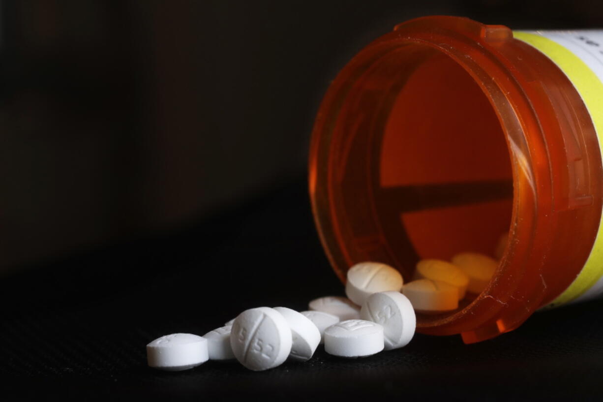 FILE - An arrangement of Oxycodone pills sit next to a bottle in New York on Aug. 29, 2018. A long-awaited review of prescription opioid medications, including their risks and contribution to the U.S. overdose epidemic, is still underway at the Food and Drug Administration, the agency's commissioner said Tuesday, Aug. 30, 2022.