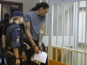 WNBA star and two-time Olympic gold medalist Brittney Griner, right, enters a cage in a courtroom prior to a hearing in Khimki just outside Moscow, Russia, Thursday, Aug. 4, 2022. Closing arguments in Brittney Griner's cannabis possession case are set for Thursday, nearly six months after the American basketball star was arrested at a Moscow airport in a case that reached the highest levels of US-Russia diplomacy.