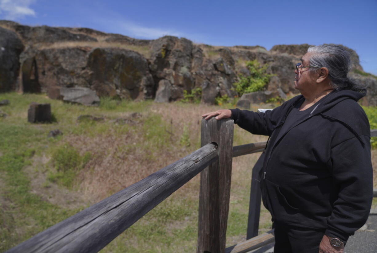 Wilbur Slockish Jr., a river chief of the Klickitat Band of the Yakama Nation, looks at petroglyphs in Columbia Hills Historical State Park on Saturday, June 18, 2022, in Lyle, Wash. In the 1980s, Slockish served 20 months in federal prison on charges of poaching salmon from the Columbia River. He says he went to prison to fight for his people's right to practice their faith.