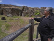 Wilbur Slockish Jr., a river chief of the Klickitat Band of the Yakama Nation, looks at petroglyphs in Columbia Hills Historical State Park on Saturday, June 18, 2022, in Lyle, Wash. In the 1980s, Slockish served 20 months in federal prison on charges of poaching salmon from the Columbia River. He says he went to prison to fight for his people's right to practice their faith.