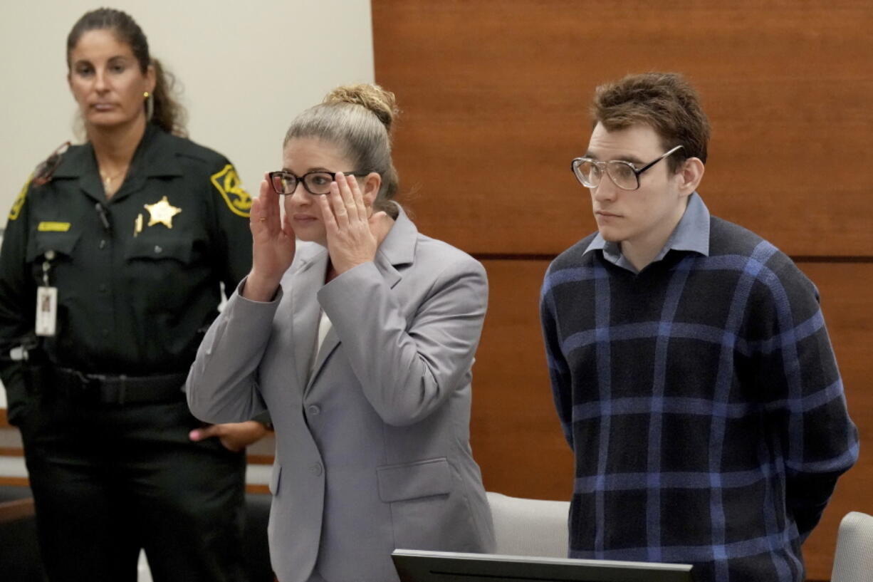 Assistant Public Defender Nawal Bashimam and Marjory Stoneman Douglas High School shooter Nikolas Cruz stand as jurors enter the courtroom during the penalty phase of Cruz's trial at the Broward County Courthouse in Fort Lauderdale, Fla., Monday, Aug. 29, 2022. Cruz previously plead guilty to all 17 counts of premeditated murder and 17 counts of attempted murder in the 2018 shootings.