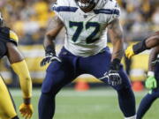 Seattle Seahawks offensive tackle Abraham Lucas (72) blocks during a preseason NFL football game against the Pittsburgh Steelers,  Saturday, Aug. 13, 2022, in Pittsburgh, Pa. Charles Cross and Abe Lucas were drafted to be the bookends to the Seattle Seahawks offensive now and in the future.