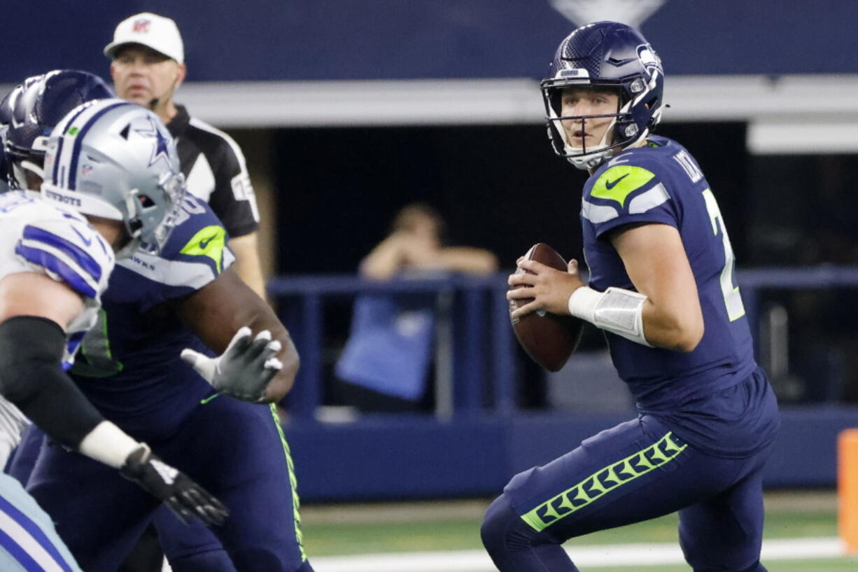 Seattle Seahawks quarterback Drew Lock (2) drops back to throw a pass in the first half of a preseason NFL football game against the Dallas Cowboys in Arlington, Texas, Friday, Aug. 26, 2022.