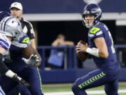 Seattle Seahawks quarterback Drew Lock (2) drops back to throw a pass in the first half of a preseason NFL football game against the Dallas Cowboys in Arlington, Texas, Friday, Aug. 26, 2022.