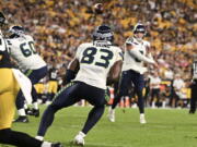 Seattle Seahawks quarterback Drew Lock, rear, throws a touchdown pass to wide receiver Dareke Young (83) against the Pittsburgh Steelers during the second half of an NFL preseason football game Saturday, Aug. 13, 2022, in Pittsburgh.