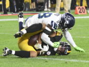 Pittsburgh Steelers tight end Connor Heyward, bottom makes a catch for a two-point conversion as Seattle Seahawks safety Ugo Amadi (28) defends during the second half of a preseason NFL football game, Saturday, Aug. 13, 2022, in Pittsburgh.