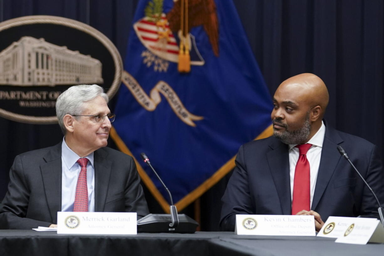 FILE - Attorney General Merrick Garland, looks at federal prosecutor Kevin Chambers, right, after appointing him to be the Justice Department's chief pandemic fraud prosecutor, during a meeting of the coronavirus disease (COVID-19) Fraud Enforcement Task Force at the Justice Department, March 10, 2022 in Washington. The U.S. Secret Service recovered $286 million in fraudulently obtained pandemic funds to the Small Business Administration, Friday, Aug. 26.