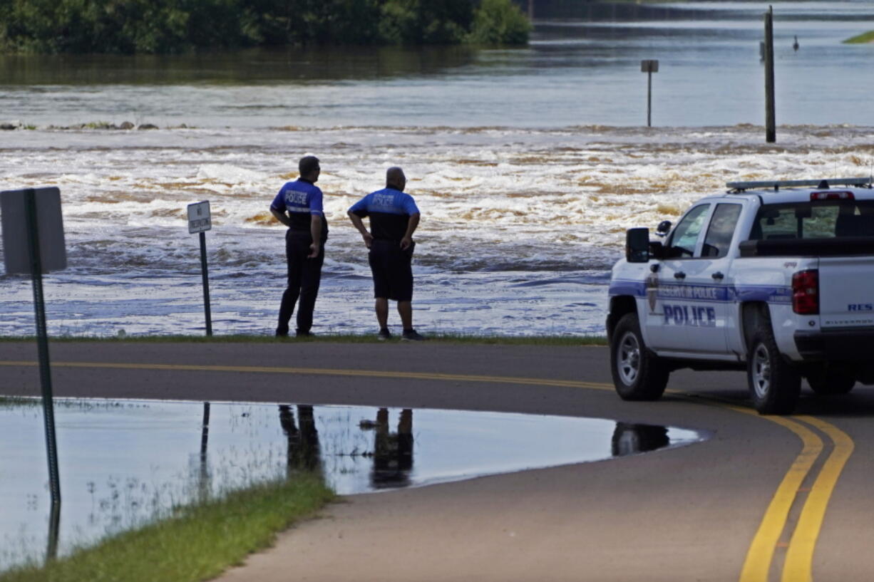 Reservoir police observe the water release from the Ross Barnett Reservoir Spillway onto the Pearl River, Sunday, Aug. 28, 2022, in Rankin County, Miss. Local officials anticipate flooding in neighborhoods near the Pearl River, the results of severe flooding from heavy rains days earlier. (AP Photo/Rogelio V.