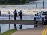 Reservoir police observe the water release from the Ross Barnett Reservoir Spillway onto the Pearl River, Sunday, Aug. 28, 2022, in Rankin County, Miss. Local officials anticipate flooding in neighborhoods near the Pearl River, the results of severe flooding from heavy rains days earlier. (AP Photo/Rogelio V.