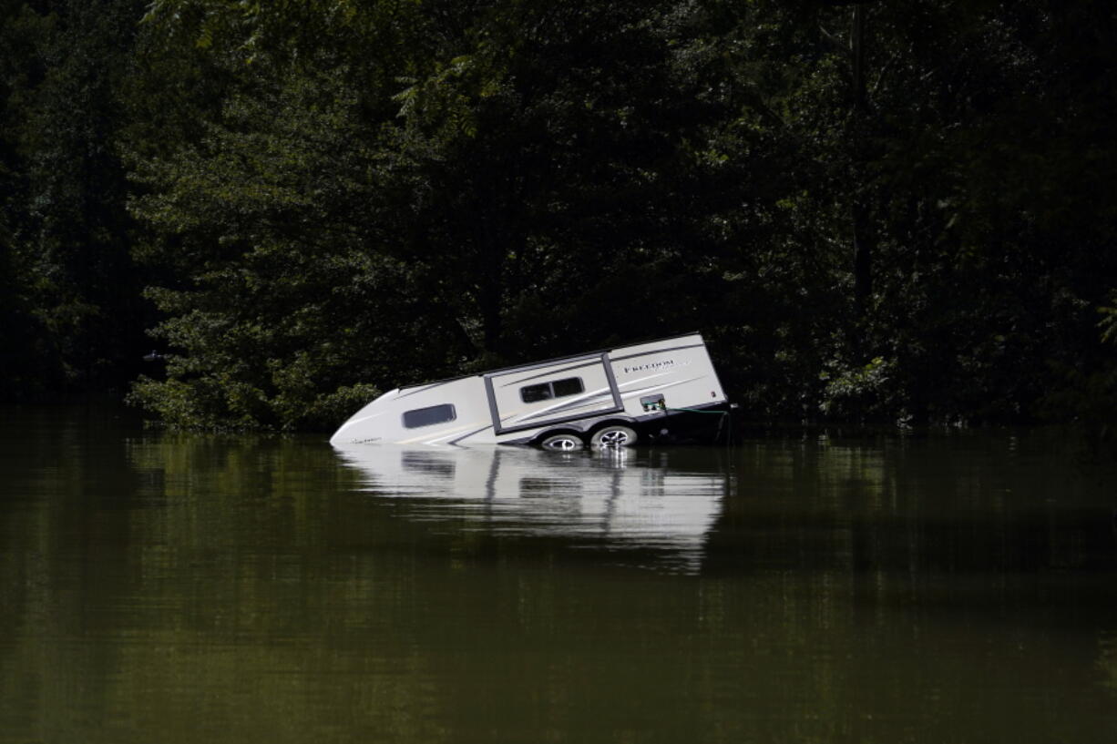 A camper is seen partly submerged under water in Carr Creek Lake on Wednesday, Aug. 3, 2022, near Hazard, Ky.