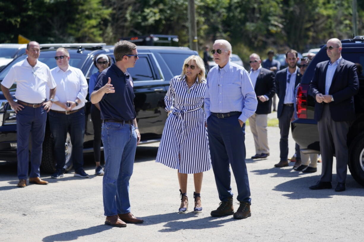 FILE - President Joe Biden and first lady Jill Biden talk with Kentucky Gov. Andy Beshear while they view flood damage in Lost Creek, Ky., Aug. 8, 2022. Beshear complained Thursday, Aug. 11, 2022, that the Federal Emergency Management Agency is denying too many requests for assistance in flood-ravaged eastern Kentucky, and urged those getting turned down to take their cases directly to agency representatives in the region.