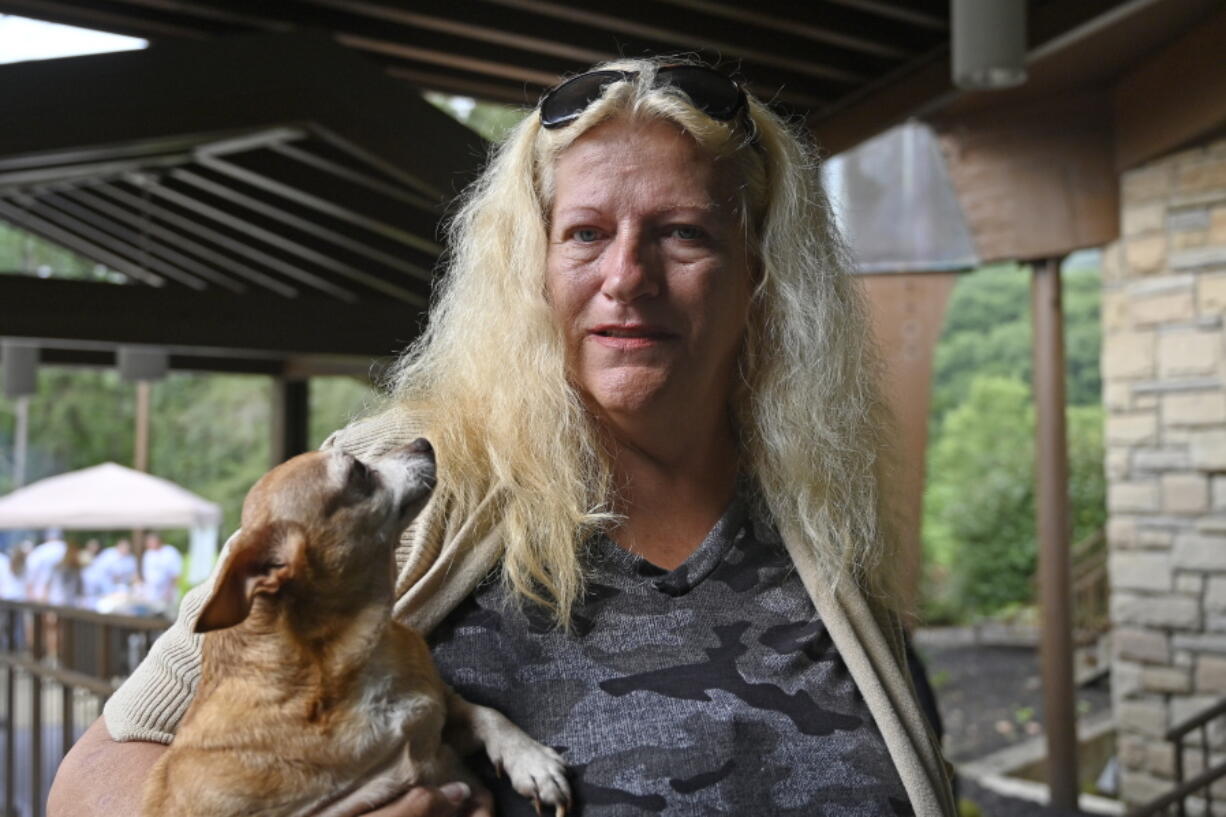 Ivallean Smith, who awoke to rising floodwaters when her pet chihuahua Coco, left, licked her hand, is being sheltered with other evacuees at Jenny Wiley State Park in Prestonsburg, Ky., Tuesday, Aug. 23, 2022. (AP Photo/Timothy D.