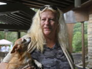 Ivallean Smith, who awoke to rising floodwaters when her pet chihuahua Coco, left, licked her hand, is being sheltered with other evacuees at Jenny Wiley State Park in Prestonsburg, Ky., Tuesday, Aug. 23, 2022. (AP Photo/Timothy D.