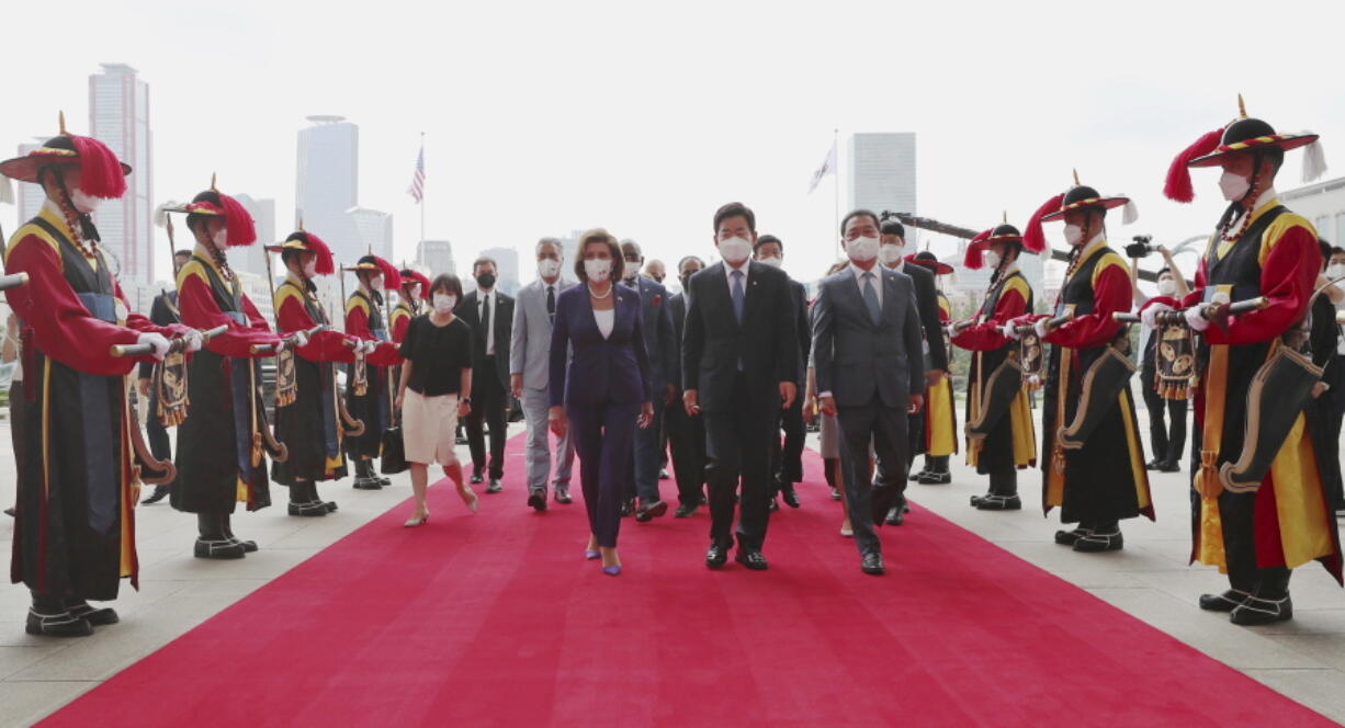 U.S. House Speaker Nancy Pelosi, center left, and South Korean National Assembly Speaker Kim Jin Pyo, center right, inspect an honor guard upon her arrival at the National Assembly in Seoul, South Korea, Thursday, Aug. 4, 2022.