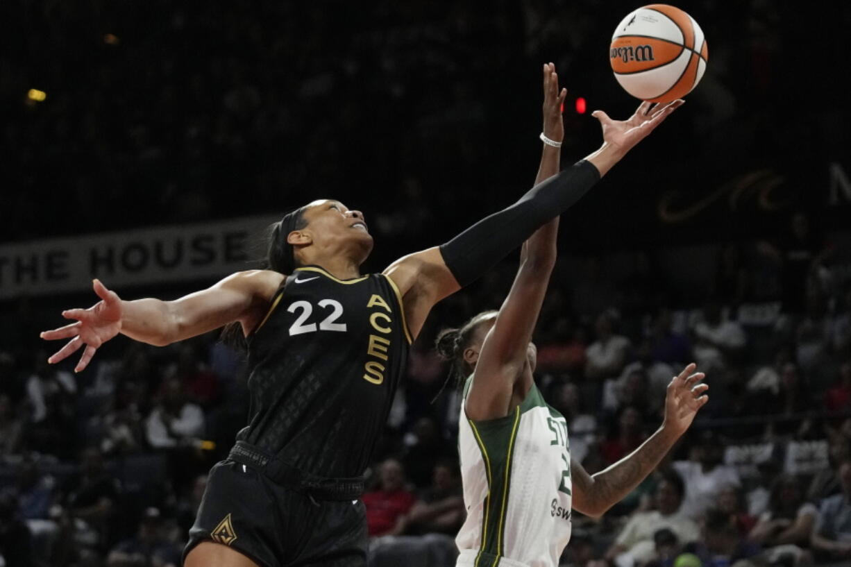 Las Vegas Aces forward A'ja Wilson (22) and Seattle Storm guard Jewell Loyd (24) battle for a rebound during the first half in Game 2 of a WNBA basketball semifinal playoff series Wednesday, Aug. 31, 2022, in Las Vegas.