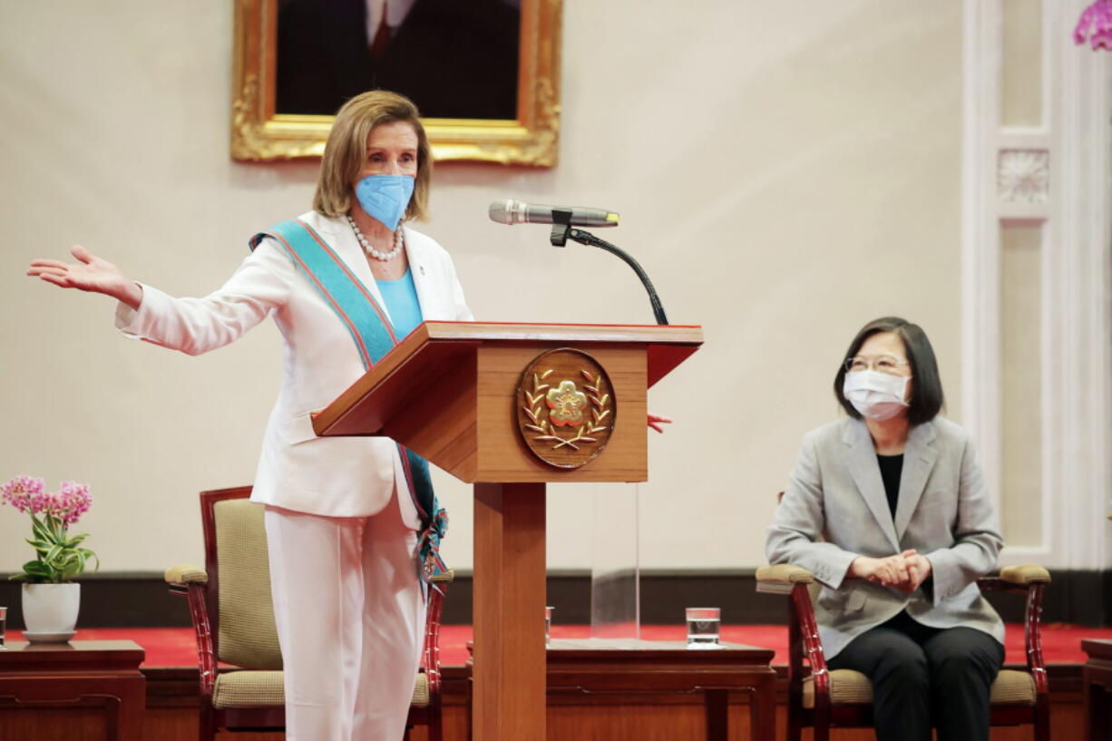 In this photo released by the Taiwan Presidential Office, U.S. House Speaker Nancy Pelosi speaks during a meeting with Taiwanese President President Tsai Ing-wen, right, in Taipei, Taiwan, Wednesday, Aug. 3, 2022. U.S. House Speaker Nancy Pelosi, meeting top officials in Taiwan despite warnings from China, said Wednesday that she and other congressional leaders in a visiting delegation are showing they will not abandon their commitment to the self-governing island.