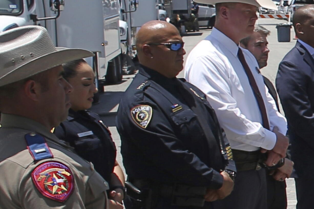 FILE - Uvalde School Police Chief Pete Arredondo, third from left, stands during a news conference outside of the Robb Elementary school on May 26, 2022, in Uvalde, Texas. Arredondo is set to face becoming the first officer to lose his job over the slow and bungled law enforcement response to one of the deadliest classroom shootings in U.S. history. The Uvalde Consolidated Independent School District board will make their decision Wednesday, Aug. 24, in a rescheduled meeting from July on Pete Arredondo's future.