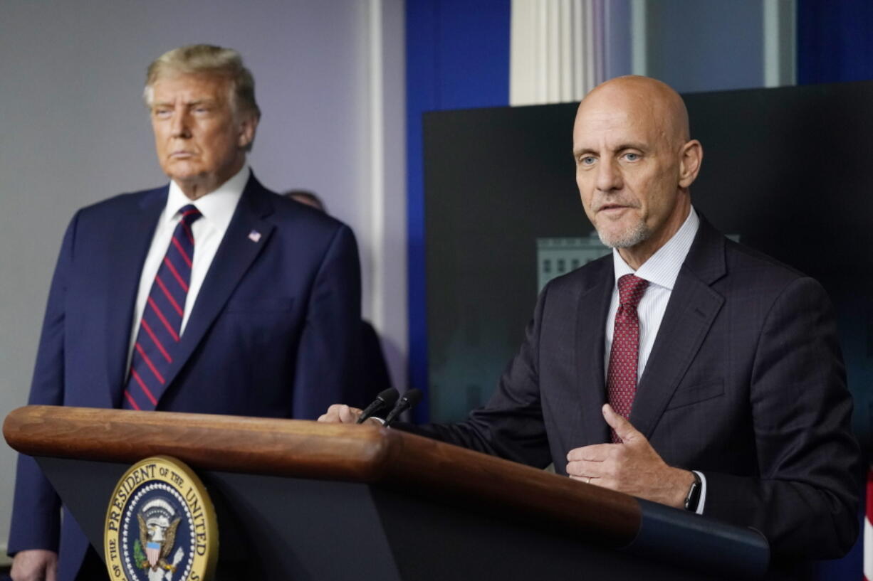 FILE - President Donald Trump listens as Dr. Stephen Hahn, commissioner of the U.S. Food and Drug Administration, speaks during a media briefing in the James Brady Briefing Room of the White House, Aug. 23, 2020, in Washington. Officials in the Trump White House tried to pressure U.S. health experts into reauthorizing a discredited COVID-19 treatment, according to a congressional investigation that provides new evidence of that administration's efforts to override Food and Drug Administration decisions early in the pandemic.