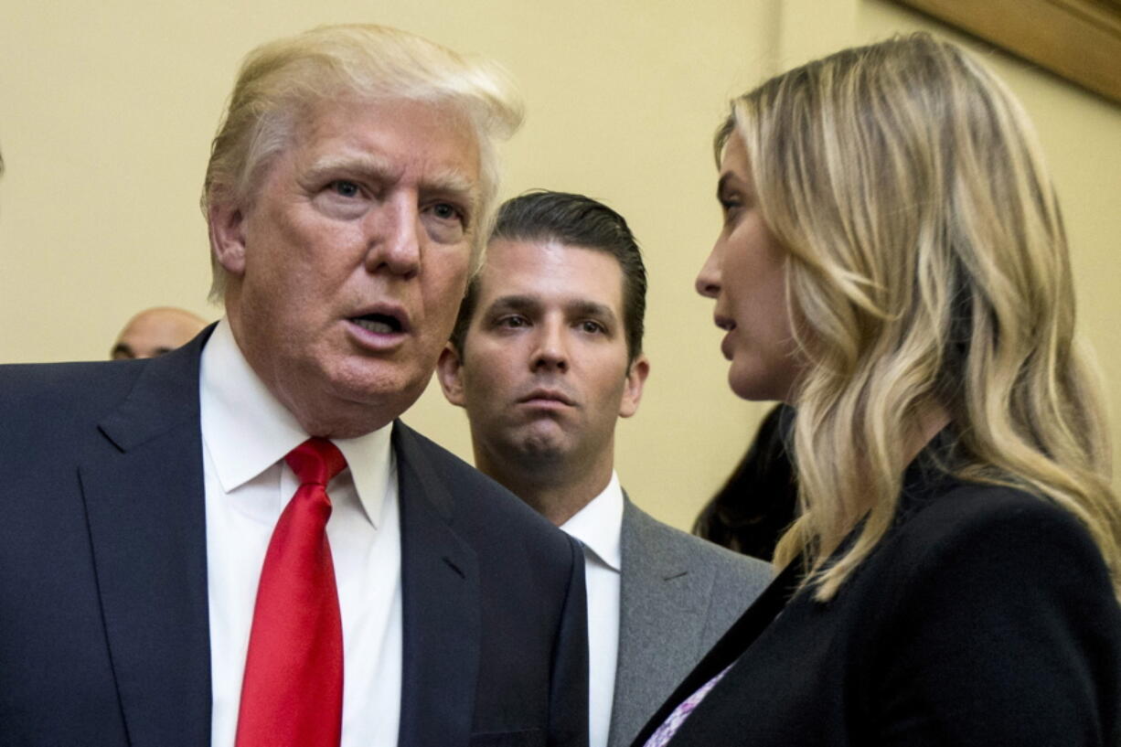 FILE - Donald Trump, left, his son Donald Trump Jr., center, and his daughter Ivanka Trump speak during the unveiling of the design for the Trump International Hotel, in Washington, Sept. 10, 2013. Former President Trump and two of his children got their questioning postponed Friday, July 15, 2022, in a New York civil investigation into their business dealings, a delay that follows the death of Trump's ex-wife Ivana.