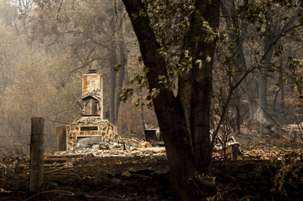 A chimney stands at a home destroyed by the McKinney Fire on Tuesday, Aug. 2, 2022, in Klamath National Forest, Calif.