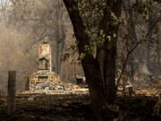 A chimney stands at a home destroyed by the McKinney Fire on Tuesday, Aug. 2, 2022, in Klamath National Forest, Calif.