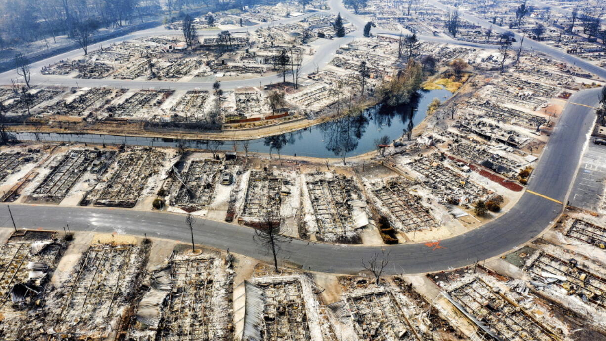 FILE - This aerial image taken with a drone shows homes leveled by the Almeda Fire line at Bear Lake Estates in Phoenix, Ore., on Sept. 15, 2020. A new map in Oregon that rated the wildfire risk of every tax lot in the state, labeling nearly 80,000 properties as high-risk, generated so much pushback from angry homeowners that officials abruptly retracted it, saying they had not done enough local outreach before publicizing the ambitious project.