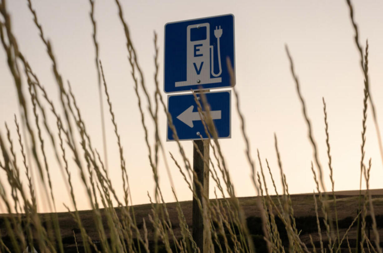 A sign just off Highway 195 points the way to the electric vehicle charging station that was recently installed at the historic gas station in Rosalia, Washington.