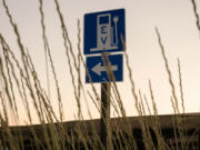 A sign just off Highway 195 points the way to the electric vehicle charging station that was recently installed at the historic gas station in Rosalia, Washington.