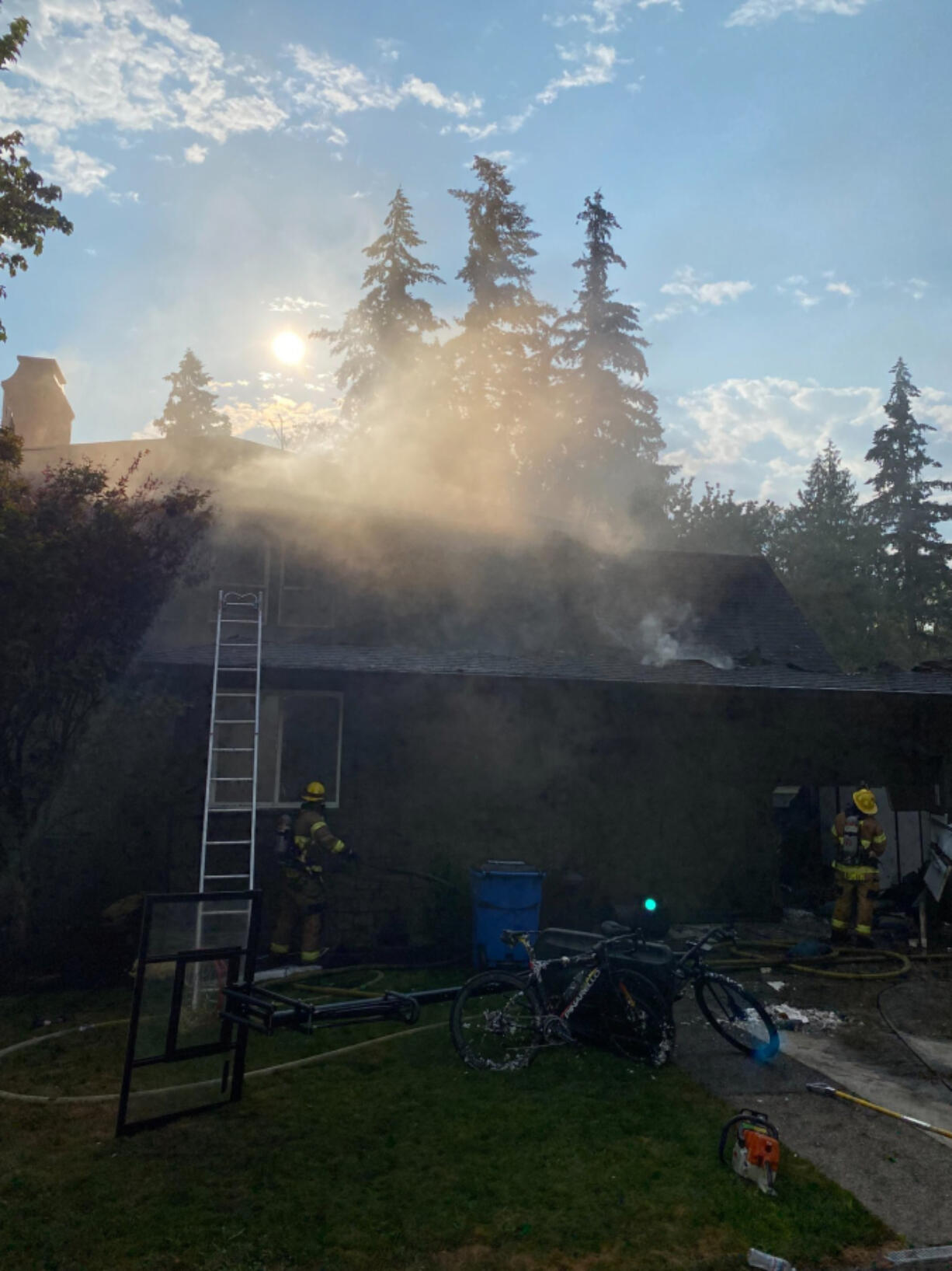 Smoke coming from a 5,000-square-foot house in Ridgefield where an attic fire displaced two people Monday morning. No one was home when firefighters arrived.