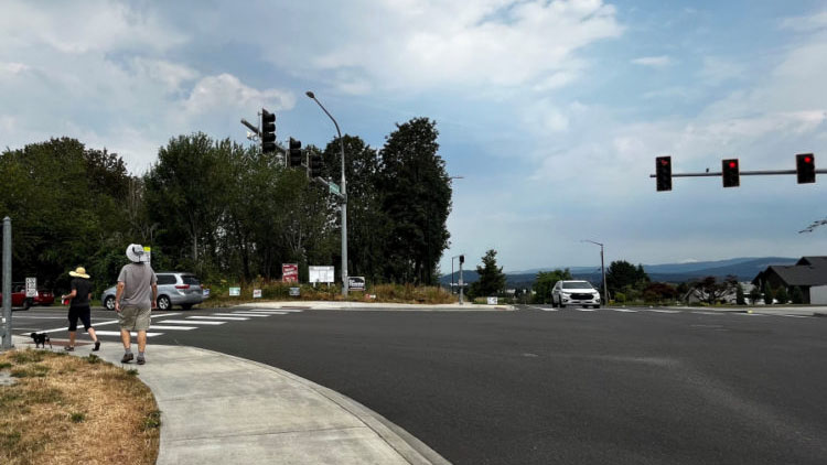 A couple walks near the intersection of Northwest Brady Road and 16th Avenue on Aug. 1.