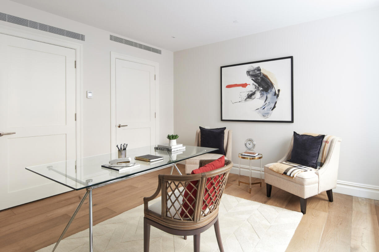 A glass desk adds a sense of transparency and openness in a home office.