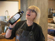 Chef and author Maria Loi of New York holds a bottle of olive oil during a class for "olive-curious youth" Sept. 2 at the University of California Davis Olive Center.